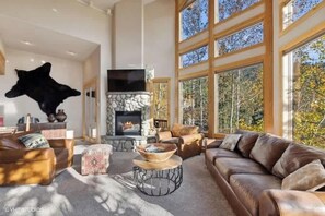 Living room Great room with gas fireplace, flat screen tv and with mountain, Flathead valley and chair six views 