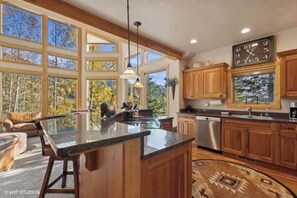 Kitchen with stainless appliances, granite counters and Island with bar seating is the perfect gathering space to host family and friends  