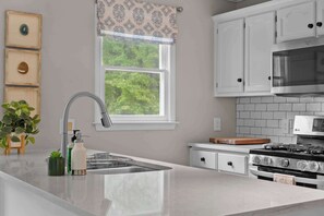 The open, airy kitchen offers ample space & all the comforts of home