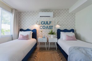 Relax in comfort with two twin beds, and ambient hanging lights.