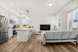 Unwind in the spacious living room, complete with a smart TV, a futon sofa bed, and an additional foldable twin cot stored in the closet, allowing the space to sleep up to 6 guests. Extra memory foam padding is available for maximum comfort, making it the