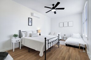Bedroom with queen size bed, a full size bed, and a twin size bed.