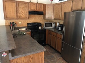 Frosty 1 - Full Kitchen with Refrigerator, Stove, Microwave, Dishwasher, and Coffee Pot