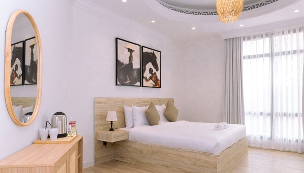 Wake up to natural light flooding this airy bedroom with a serene, minimalist design.
