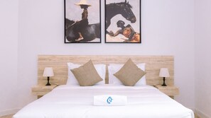 Relax in this cozy bedroom featuring warm tones and unique artwork above the bed.
