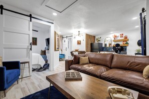 Living room with bedroom on left and kitchen to right