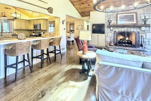 Great room, island seating dining room, looking down hallway to guest rooms