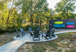 This inviting fire pit area is perfect for cozy nights, offering comfortable seating and plenty of space for everyone to relax and enjoy the crackling fire.