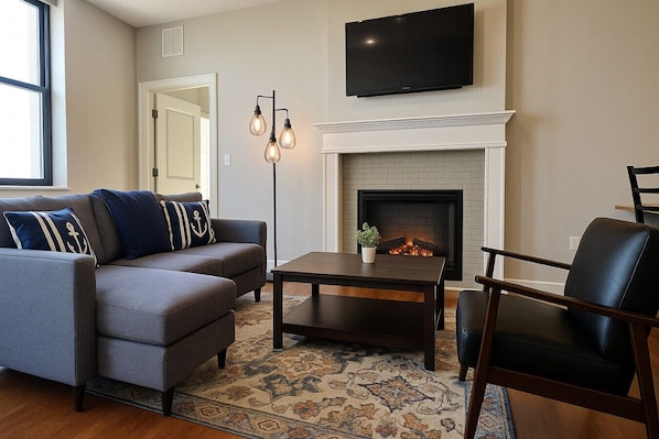 Cozy Living Room – Fireplace, Smart TV & Stylish Seating for Relaxation