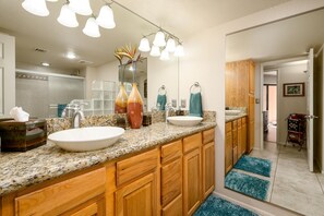 Raised vanity with double sinks and granite countertops