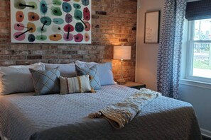 [Master Bedroom] King bed, 50" HDTV (YouTube TV provided) and a walk-in closet are on the opposite wall; above, a ceiling fan.