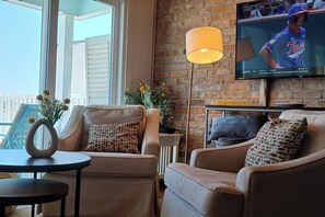 [Upper living space] 56" HDTV, ceiling fan overhead.