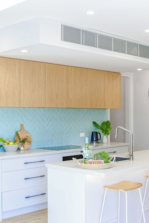 Open plan kitchen with oven, stove, fridge freezer with water and ice, coffee machine and more