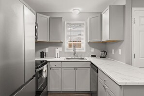 Modern kitchen with cabinets and ample space.