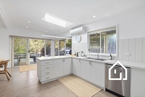 The kitchen area has easy access to the deck