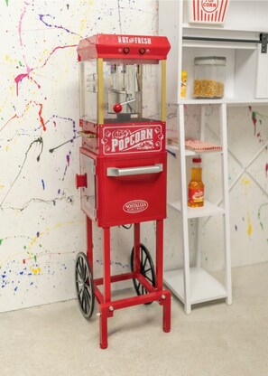 Old school popcorn maker in the game room.