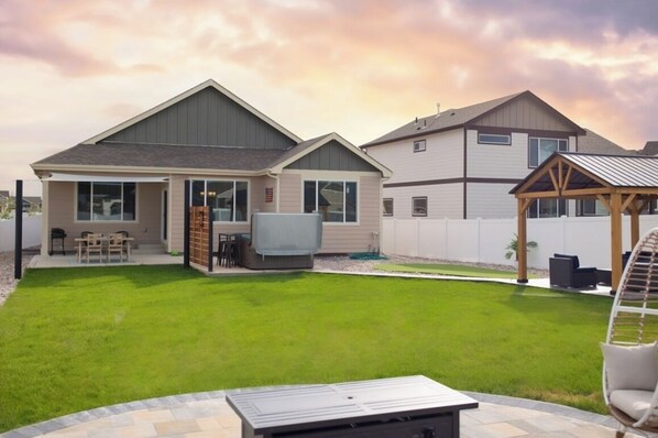 Backyard perfect for fun! Enjoy Cornhole, fire pit, hot tub, putting green.