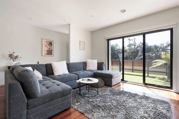The living room is a comfortable space to relax throughout your day, perhaps with a good book or spot of TV.
