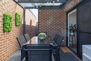 Alfresco dining is strung with fairy lights, a perfect spot to soak up the coastal air as you enjoy some BBQ with the family.
