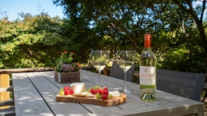 The beautiful deck patio offers a shady and relaxing outdoor dining area.