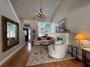 Open concept living space with floor to ceiling windows and new modern furnishes