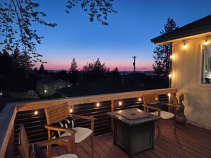 Back deck with panoramic views, propane fire pit table, and teak deck chairs