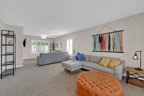 A separate family room provides a cozy space for relaxation, ideal for unwinding after a day of work or play.