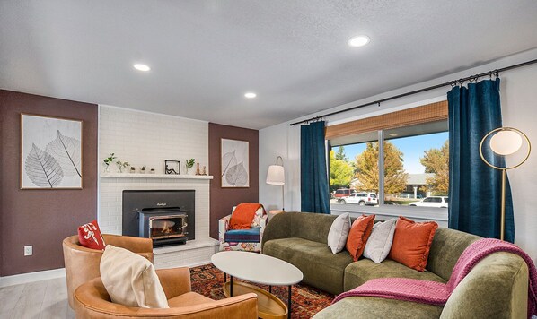 A vibrant and stylish main living room, filled with bold colors and chic decor, perfect for relaxing or entertaining.