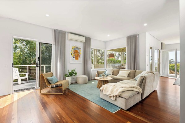 Lounge room one - open plan with views looking over the bay