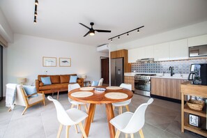The kitchen is fully equipped and the cozy dining table has a seating for 4