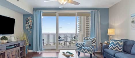 Open concept living area with stylish furnishings, TV, and scenic views. Features a queen size pullout sofa as well.