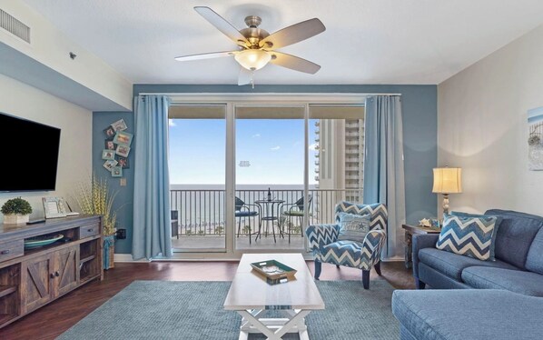 Open concept living area with stylish furnishings, TV, and scenic views. Features a queen size pullout sofa as well.
