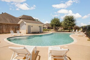 Swimming pool with sun loungers