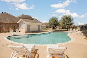 Swimming pool with sun loungers