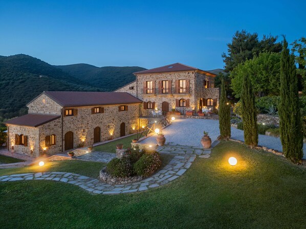 Lit stone villa, breathtaking Amalfi views, lush hills & near-beach retreat.