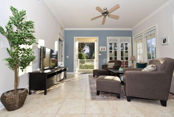 Bright and spacious living room with cozy seating and plenty of natural light.