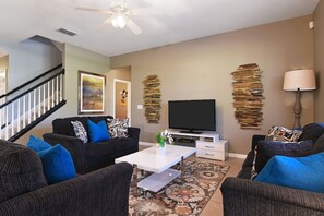 nwind in the stylish living room featuring plush seating, a TV, and tasteful decor for your comfort.