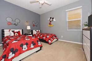 Cozy up in this Mickey-themed kids’ bedroom, a magical retreat for the little ones in your group.