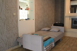 A convertible sofa bed is suitable for two average-sized people —simple comfort.