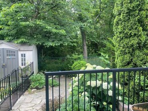 The backyard is divided between the homeowner and guests. Guests can enjoy their private section of the backyard and their own patio.