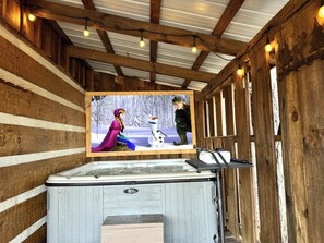Enjoy a movie or show on our Roku projector while relaxing in the hot tub!