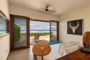 Wake up to stunning ocean views from this elegantly decorated bedroom, complete with direct access to the outdoor lounge.