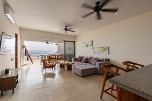 A stylish and spacious living area featuring a cozy seating arrangement, modern decor, and direct terrace access.