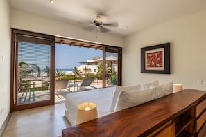 Wake up to ocean views in this serene master suite, featuring warm wood tones and seamless indoor-outdoor living.