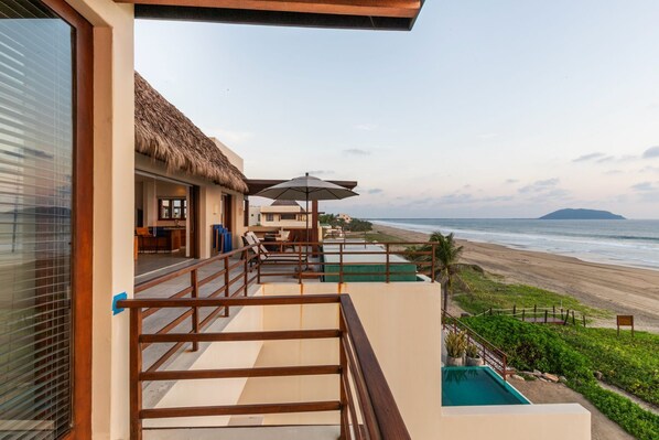 Relax on this private balcony, complete with breathtaking ocean views, comfortable seating, and a refreshing plunge pool.