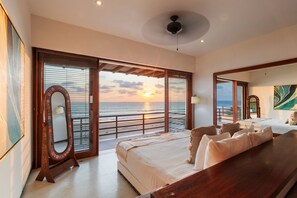 Wake up to stunning ocean sunrises in this master suite, featuring floor-to-ceiling windows and direct balcony access.