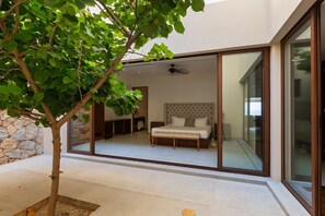 Wake up to nature in this elegant master suite, featuring direct access to a private outdoor space.