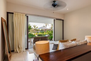 A tranquil outdoor space featuring a shaded pergola, comfortable seating, and direct access to the plunge pool.