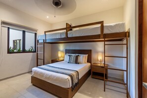 A unique bunk room featuring a queen-size bed below and an elevated twin, perfect for families or groups.