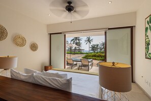 Wake up to paradise in this master suite, featuring a private oceanfront patio, minimalist decor, and natural lighting.